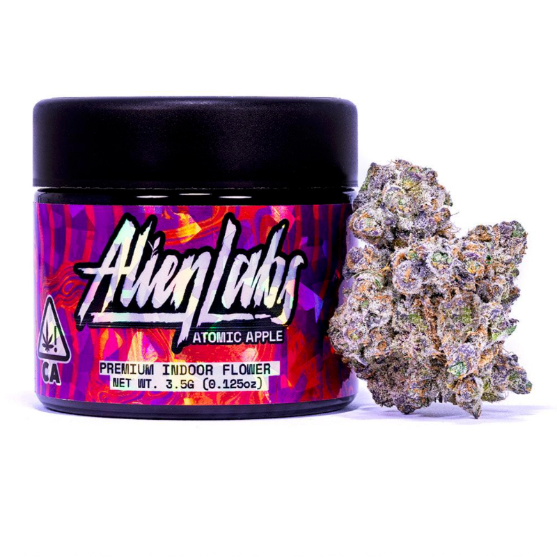 Jar of Alien Labs Atomic Apple cannabis with a large cannabis bud on a white background