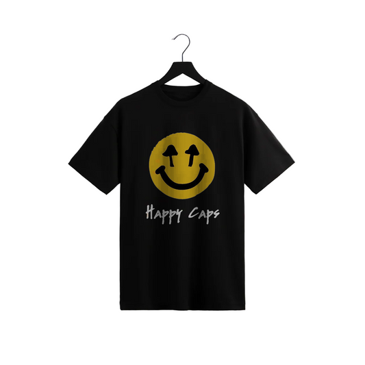 Happy Caps black graphic t-shirt featuring yellow smiley face with mushroom eyes and handwritten-style text, trendy psychedelic streetwear design on hanger.