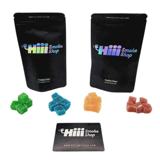 Assorted THC gummies in front of Hiii Smoke Shop branded black packaging and business card, featuring 600mg 20-pack edibles from hiii-delivery.com.